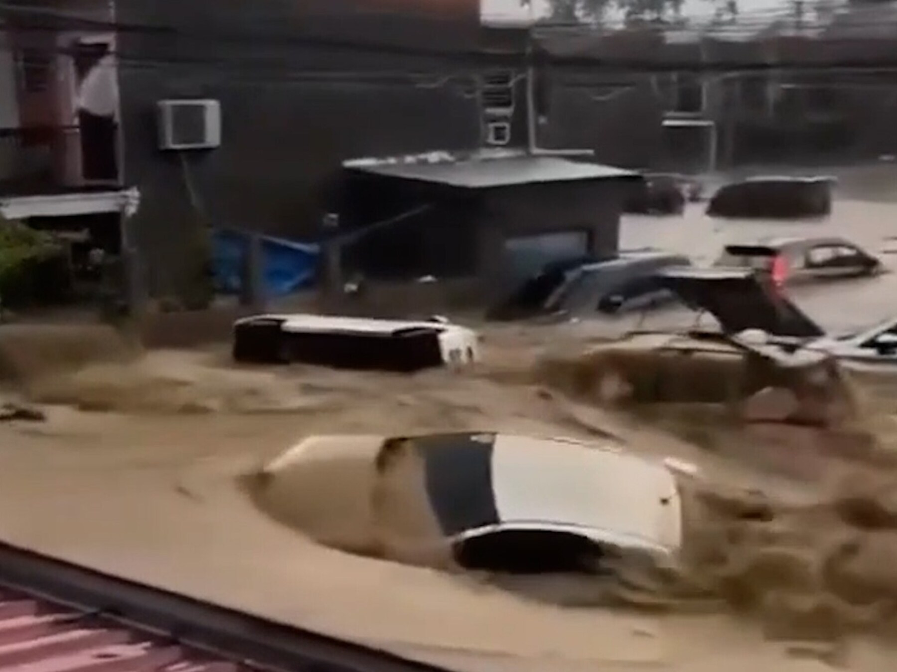 Kolkend water sleurt auto's mee op Filipijnen